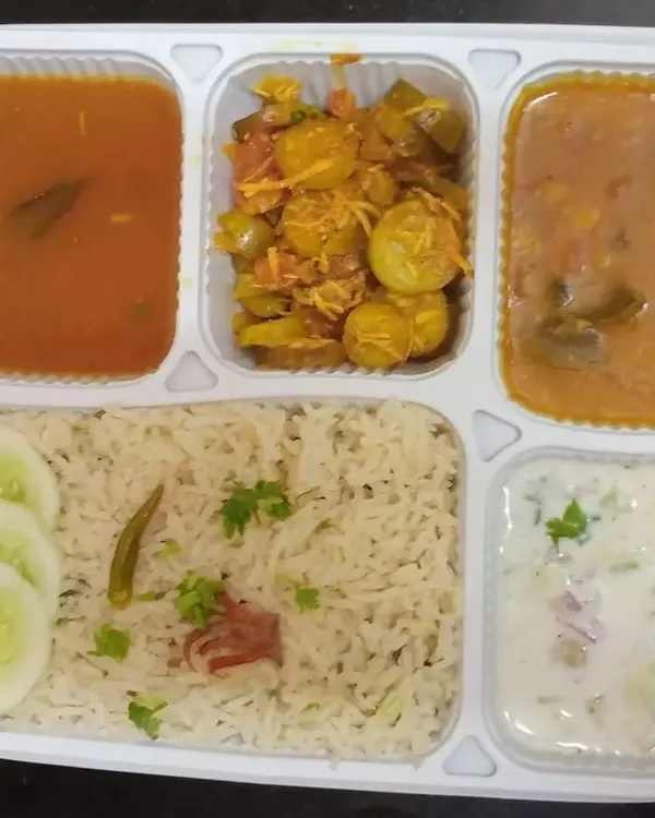 This is the heart of our service: a complete, balanced, and delicious homemade vegetarian thali. This meal includes fluffy rice, wholesome dal, a seasonal vegetable sabzi, tangy sambar, and fresh raita, providing a nutritious and satisfying lunch or dinner.