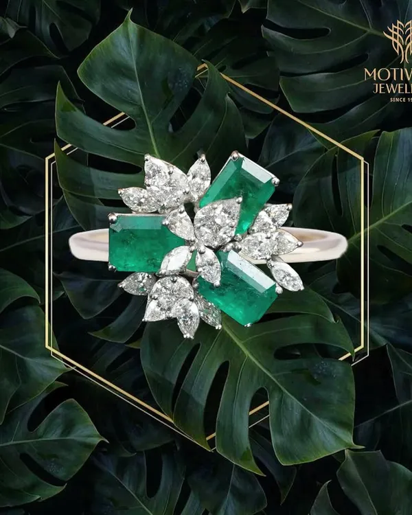 Nature's beauty is captured in this striking ring, where vibrant emeralds are juxtaposed with marquise and pear-shaped diamonds. It is a piece of wearable art for the discerning collector.