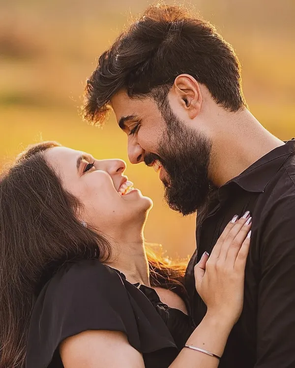 There is nothing more beautiful than the sound of shared laughter at sunset. This golden hour shot is all about the pure, unadulterated joy that comes from being with your favorite person.