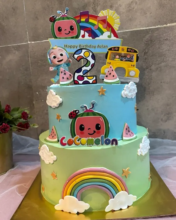 This two tier CoComelon cake is a favorite for second birthdays. It's packed with fun details, including JJ, the yellow bus, and lots of rainbows and watermelons. The pure joy on the birthday boy's face in the next photo says it all.