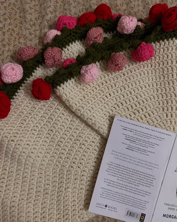 I'm completely obsessed with how this rose bouquet blanket turned out. Here's a close-up shot where you can see the detailed stitching of the blanket and the texture of the pink and red roses along the border.