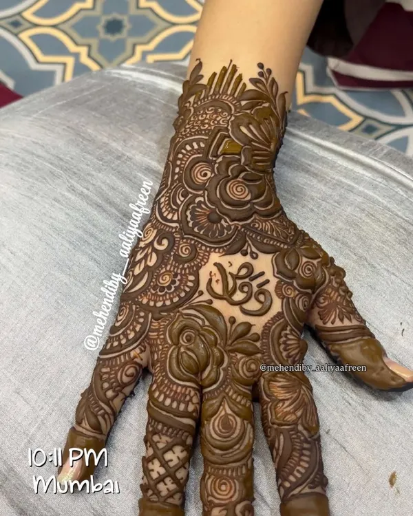 A beautiful, intricate design featuring a client's name elegantly written in Arabic script on the palm.