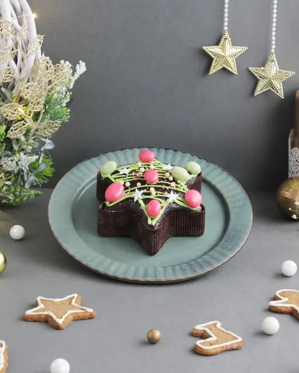 Unwrap the joy of Christmas with our delectable plum cakes. This one is shaped like a Christmas tree and decorated with festive colors, making it a perfect centerpiece.