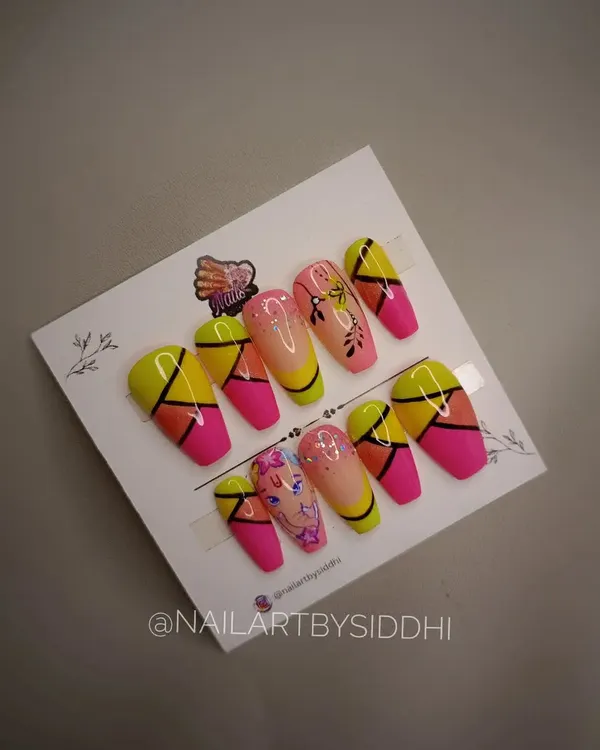 A vibrant and festive press-on set designed for Ganesh Chaturthi, featuring bright colors and character art.