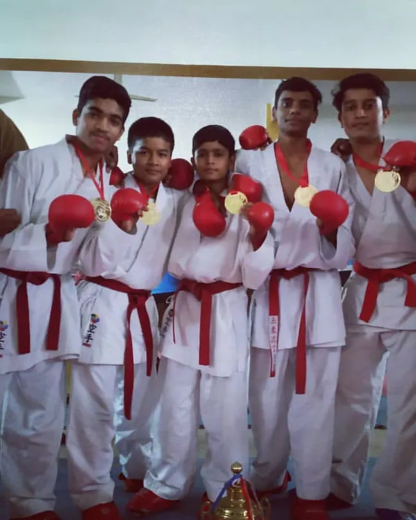 This is the result of teamwork and shared dedication. My sub-junior team proudly displays their gold medals after winning the team Kumite event. We fight together and we win together.