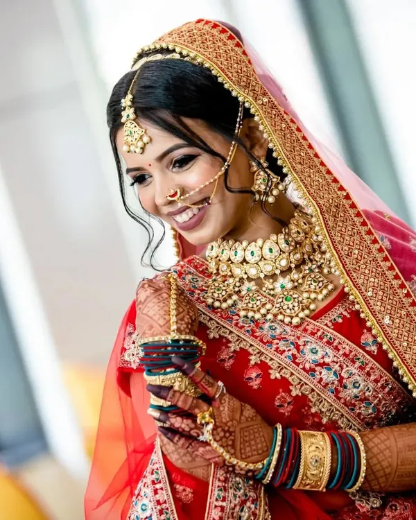 This is what pure joy looks like. I love creating complete bridal looks, like this stunning Kundan choker set with a matching maang tikka and nath, that make my brides feel radiant and confident on their special day.