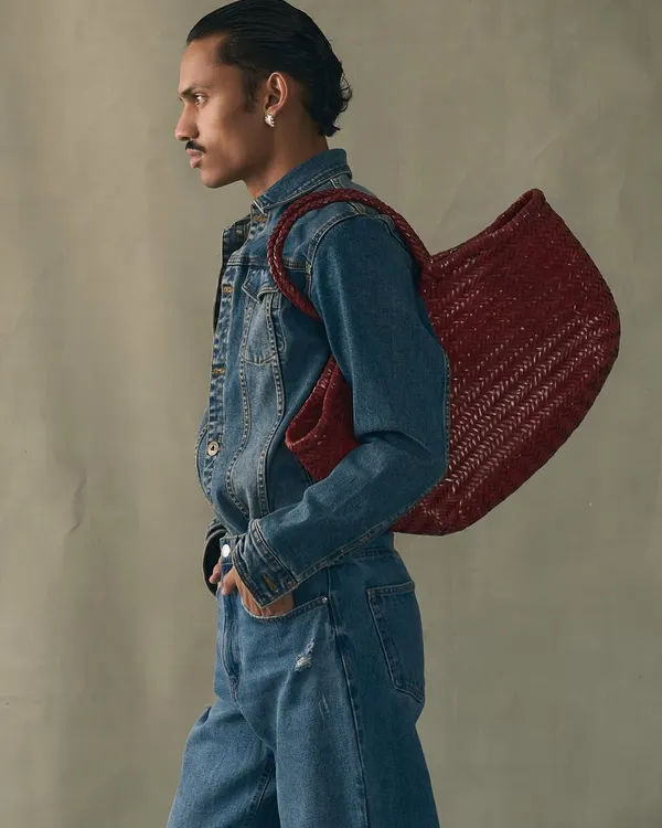 A model wearing our large handwoven tote in a striking red. This bag is crafted to last a lifetime, not just a season, embodying our commitment to slow fashion and artisan quality.