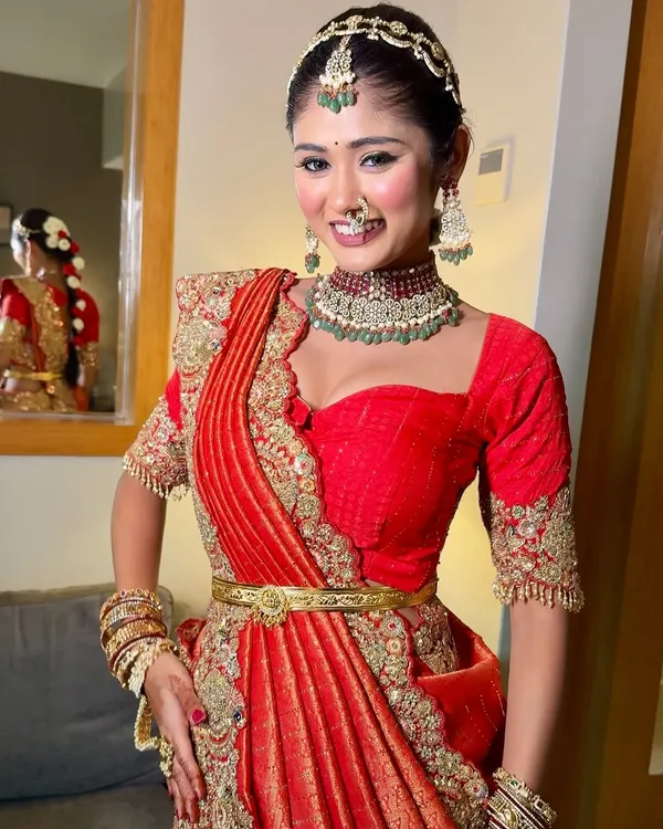 This is the smile I aim for. A happy bride feeling confident and beautiful in a perfectly draped, heavy embroidered red saree for her big day.