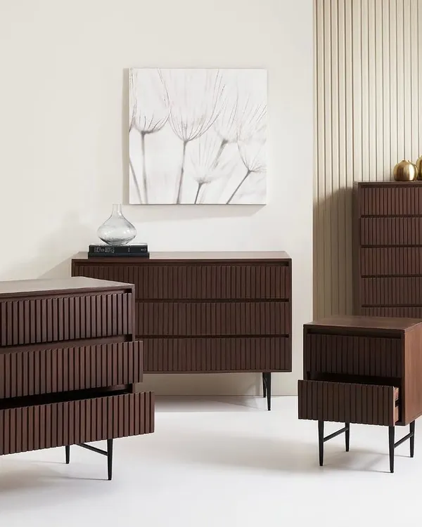 A group shot of the 'Slatted Collection' for a UK brand. This image effectively displays the range of pieces available, including chests of drawers and a nightstand, in a clean, contemporary setting.