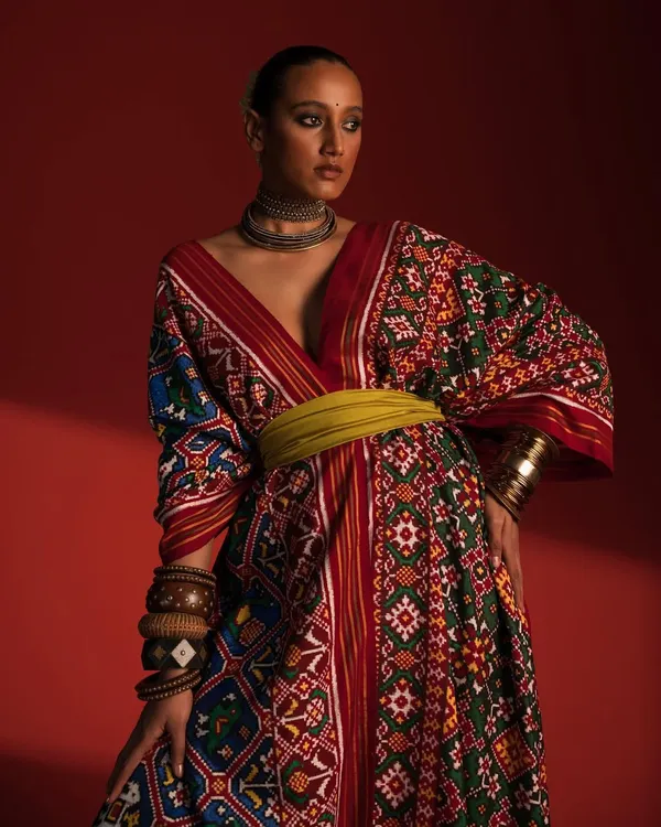 Here, I've styled a traditional Patola-inspired kaftan from Ravissant, blending heritage textiles with a modern silhouette. The rich colors and patterns are balanced with a contemporary waist belt and minimal accessories to create a striking, culturally relevant fashion statement.