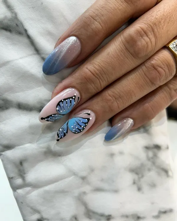 A close-up of our incredibly detailed, hand-painted butterfly wing. We combine this with a blue ombré and cat eye effect for a truly magical manicure.