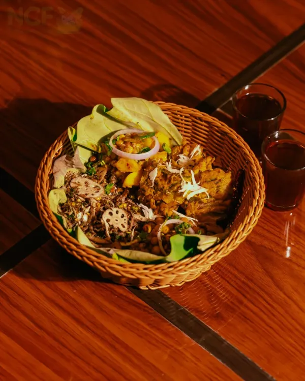 My Manipuriness Relish Munch basket, featuring a mix of Singju, Bora, and other snacks, served with traditional black tea (Cha-ngang).