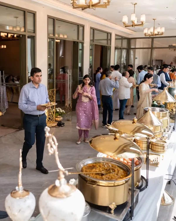Guests enjoying a seamless buffet experience at an elegant indoor event. My setups are designed for easy flow, ensuring everyone can comfortably enjoy the wide array of dishes offered.