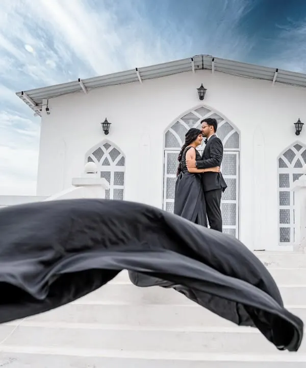 We create dramatic, cinematic moments using our modern architectural sets like this 'White House' backdrop. The grand staircase and clean white aesthetic are perfect for elegant pre-wedding photos that make a statement.