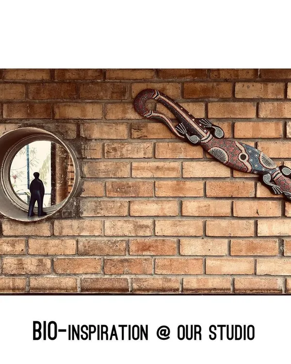 Bio-inspiration is everywhere in our studio. This tribal lizard art, mounted on an exposed brick wall next to a circular window, reflects our love for nature, craft, and looking at the world from different perspectives.