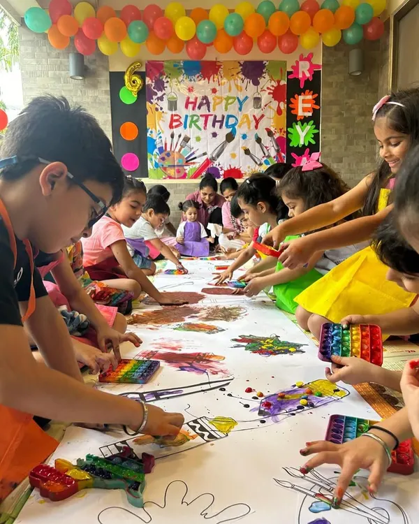 This is what a messy art birthday party looks like! I love seeing a big group of kids dive into a giant canvas, using their hands, brushes, and pure imagination to create a collaborative masterpiece. It's loud, it's colorful, and it's the heart of the celebration.