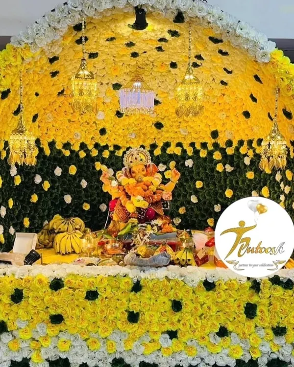 This grand floral makhar is one of our signature designs, using a dense arrangement of yellow, white, and green flowers with elegant hanging lanterns. This is the premium quality I promise for every Ganpati decoration.