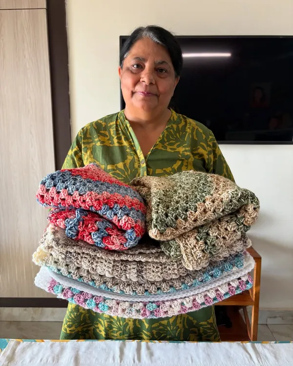 This is me, Nishtha, with a stack of freshly finished blankets. Every order we pack is filled with the same excitement and happiness as our very first one.