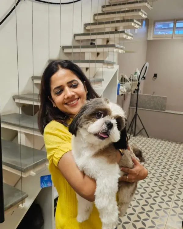 We believe in a personal touch. Here I am with a happy Shih Tzu, freshly groomed and feeling great. This is the kind of one on one attention and care every pet receives at our center.