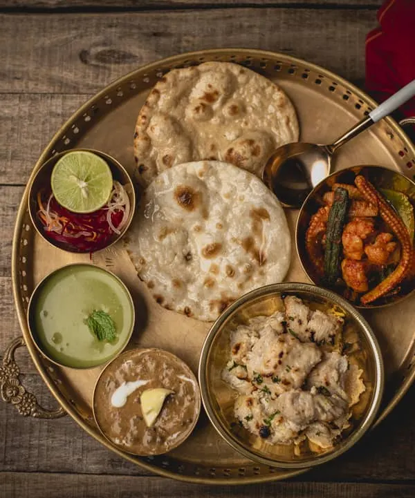 Welcome to Kund! Our famous thali is a complete, 'petful' meal, giving you a taste of our best dishes like creamy dal makhani, flavourful sabzi, and soft rotis all on one plate. It’s the perfect way to experience our authentic North Indian khana.