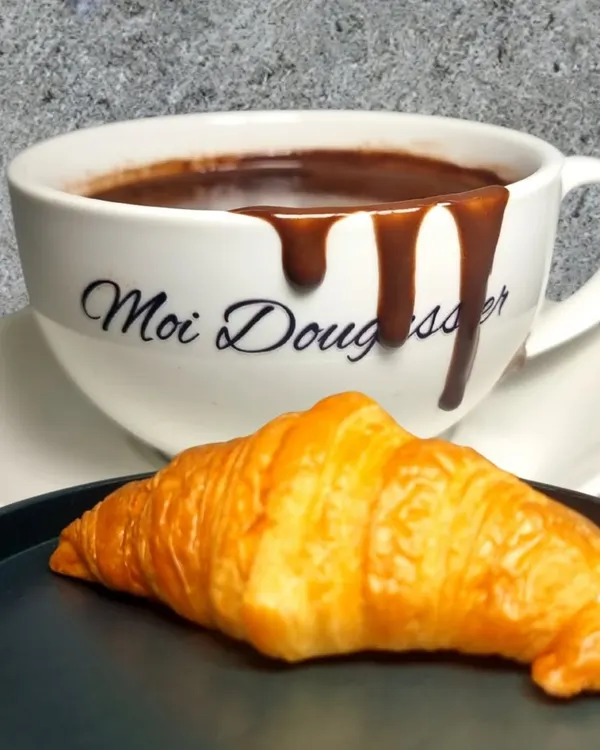The ultimate indulgence. A cup of my signature thick, velvety hot chocolate, overflowing with richness, served with a classic butter croissant perfect for dipping.