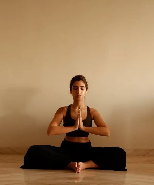 Finding stillness and focus. A moment of calm in a seated prayer pose, a practice we use to center ourselves before a class or performance.