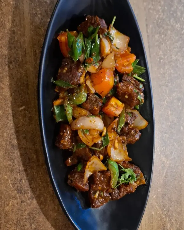 A Naga speciality, this is Pork Dry Fry with Axone. The fermented soybean gives it a unique, pungent flavour that is truly authentic to Nagaland.