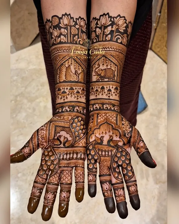 This heavy sider design is a masterpiece of traditional art. It features graceful peacocks on the palms, elephants within ornate windows on the forearms, and a beautiful border of lotus flowers at the top.