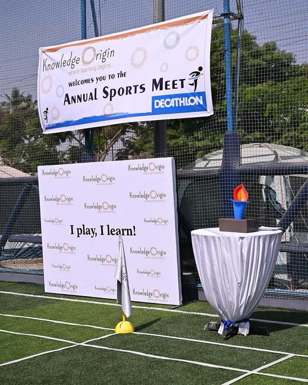 Our Annual Sports Meet is a highlight of the year. The event setup, complete with a banner and ceremonial torch, creates a sense of excitement and celebrates the children's physical achievements.
