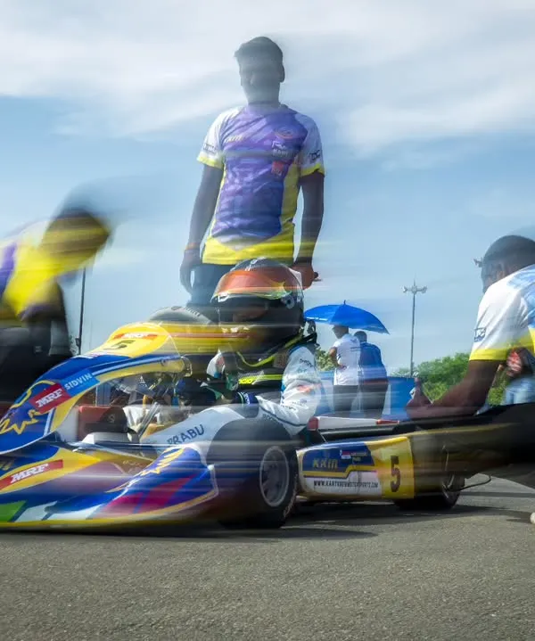 A dynamic shot of our pit crew making last-minute adjustments on the grid before a race.