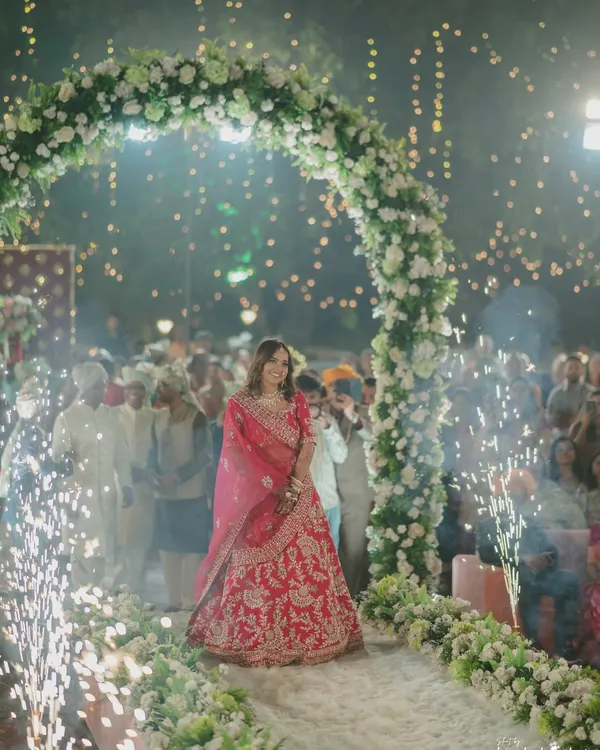 A bride's breathtaking entrance through an arch of flowers and sparklers. This is the beginning of her walk towards a new life, and we capture it with all the grandeur it deserves.