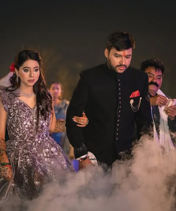 The grand entrance of the couple at their ring ceremony, walking through a dramatic cloud of smoke. This creates a truly cinematic start to the evening.