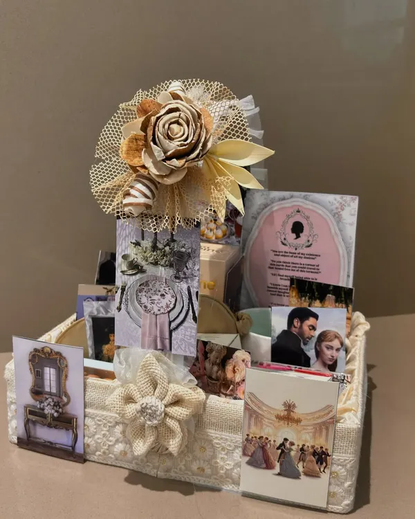 Dearest gentle reader, this Bridgerton-themed hamper is the talk of the ton. We curated it with elegant items and imagery from the show, all presented in a lace and burlap basket fit for a duchess.