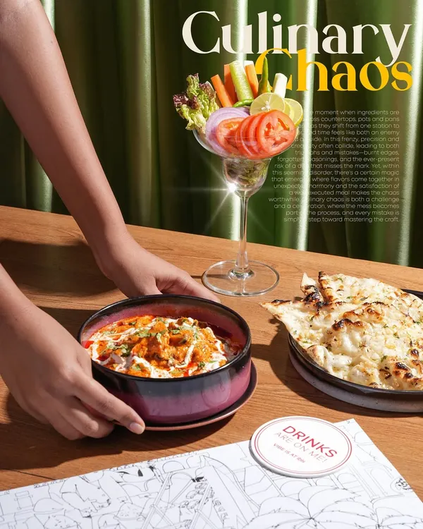 This lifestyle shot for a restaurant menu captures the moment a dish is served. Including hands in the frame makes the scene feel more dynamic and relatable, inviting the viewer to imagine themselves at the table.