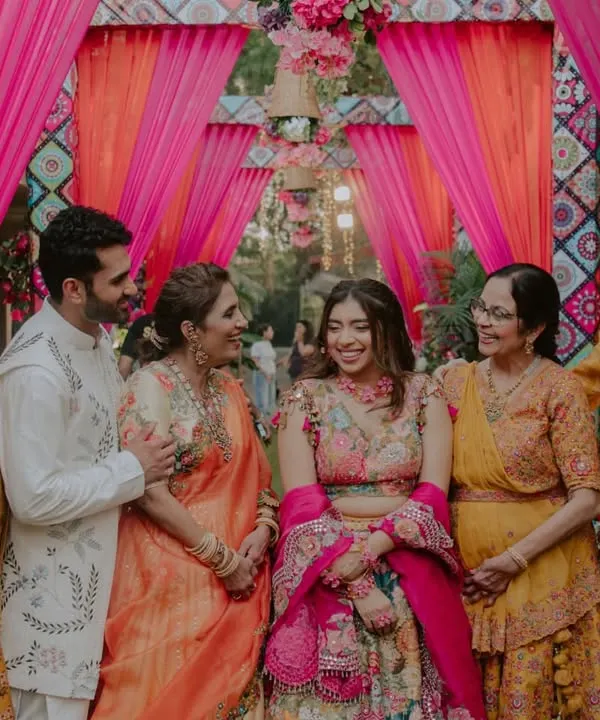 A beautiful, happy portrait of the couple with their parents. Capturing the joy of the two families coming together is one of the most important parts of our job.