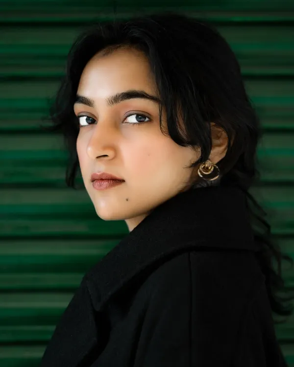 We craft powerful, clean headshots that capture your professional essence. This close-up portrait, shot against a simple background, puts the focus entirely on the subject's confident expression, making it perfect for personal branding or an artist's portfolio.