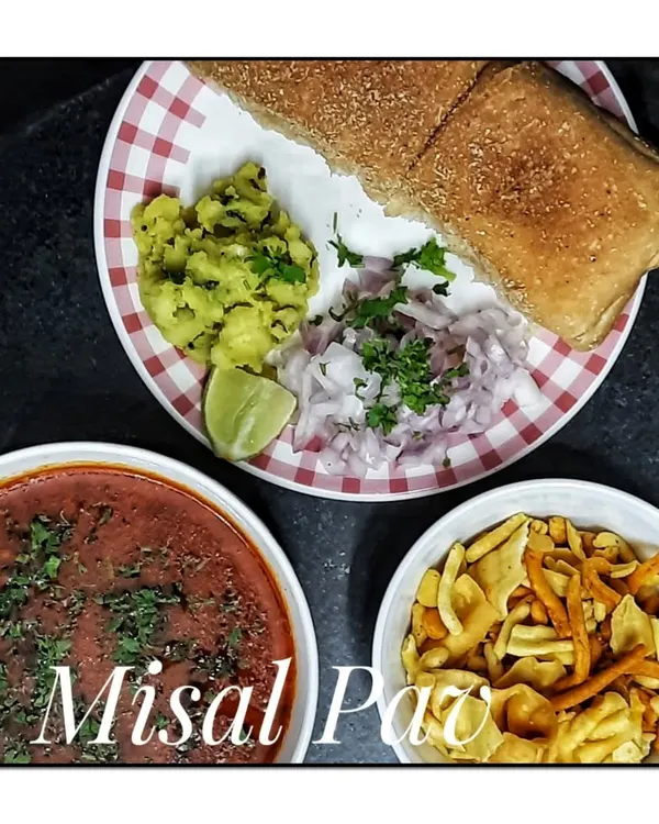 My homemade Misal Pav, a quintessential Maharashtrian breakfast and snack. It is served with spicy sprouted lentil curry, farsan, chopped onions, and soft pav, just the way it should be.