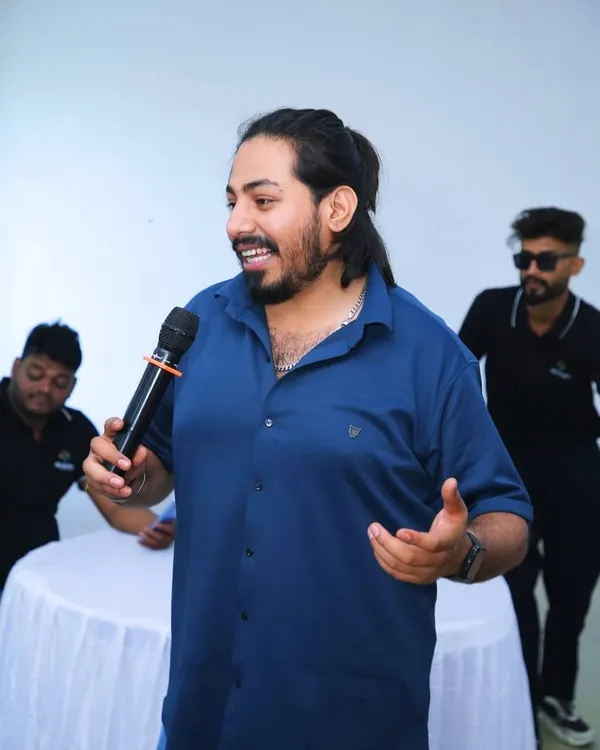 Here I am, mic in hand, doing what I love most: hosting and making sure everyone is having a great time. This is a typical moment for me, interacting with guests and keeping the party moving.