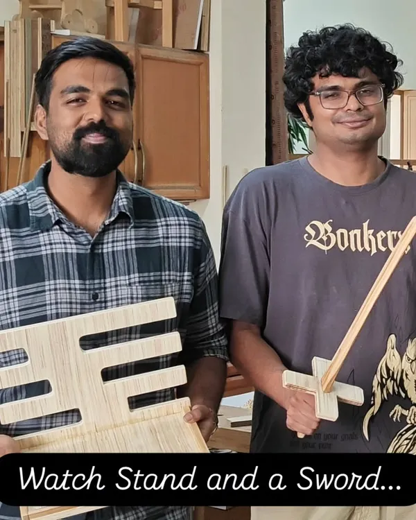 A fun assortment of projects from a workshop: a handmade wooden sword and a custom watch stand, proving that woodworking can be both playful and practical.