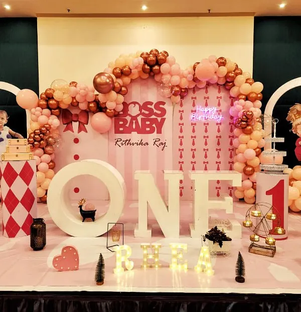 A setup fit for a boss. For this "Boss Baby" themed first birthday, we created a full stage with large marquee letters, character cutouts, and a detailed pink and rose gold balloon arrangement.