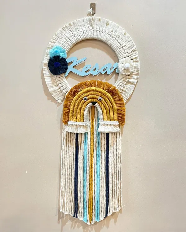 This personalized name hanging for Kesar features a brave lion rainbow design. The combination of the custom name, animal theme, and long colorful tassels makes it a standout piece for a nursery.