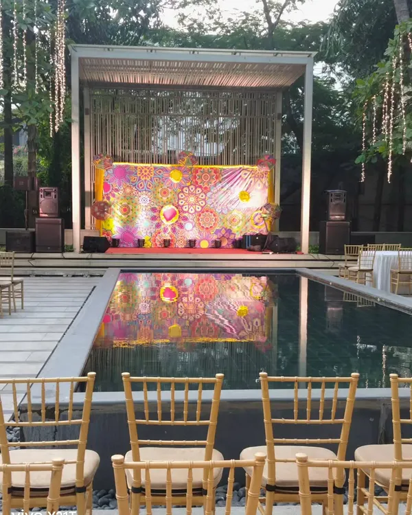 A stunning poolside stage for a corporate event. The colorful, abstract backdrop is reflected beautifully in the water, creating a high impact visual for presentations or performances.