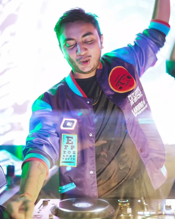 A close-up action shot of me feeling the music while mixing. This captures the passion I have for my craft.