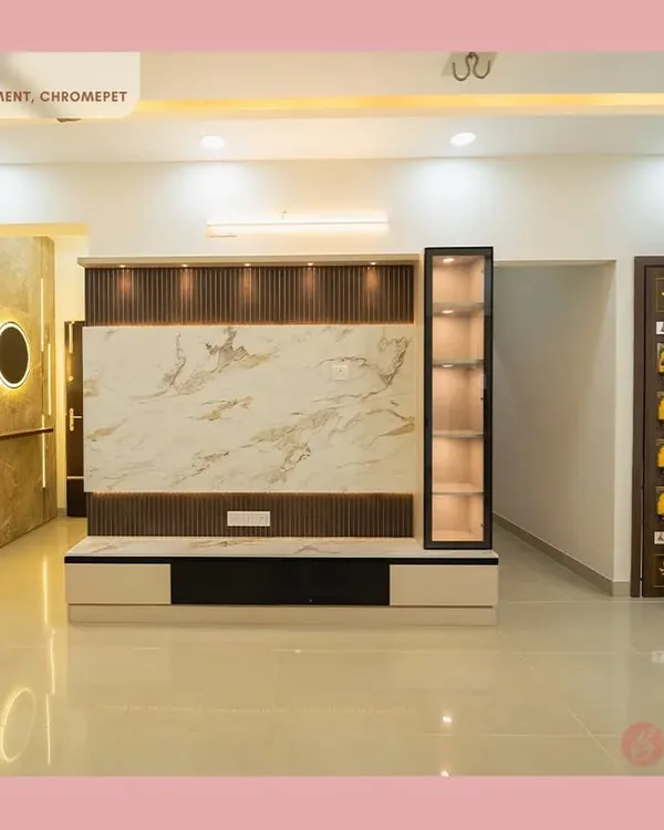 A glimpse into a complete living space we designed in Chromepet, featuring a marble-finish TV unit with fluted panels, integrated display, and an elegant, traditionally carved pooja unit door.