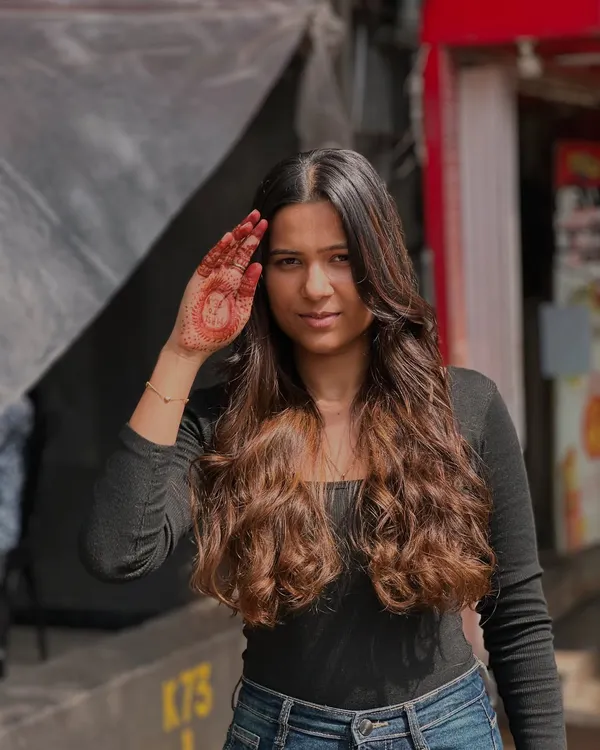 The beauty of balayage and a happy client. Her smile and confident pose say it all.