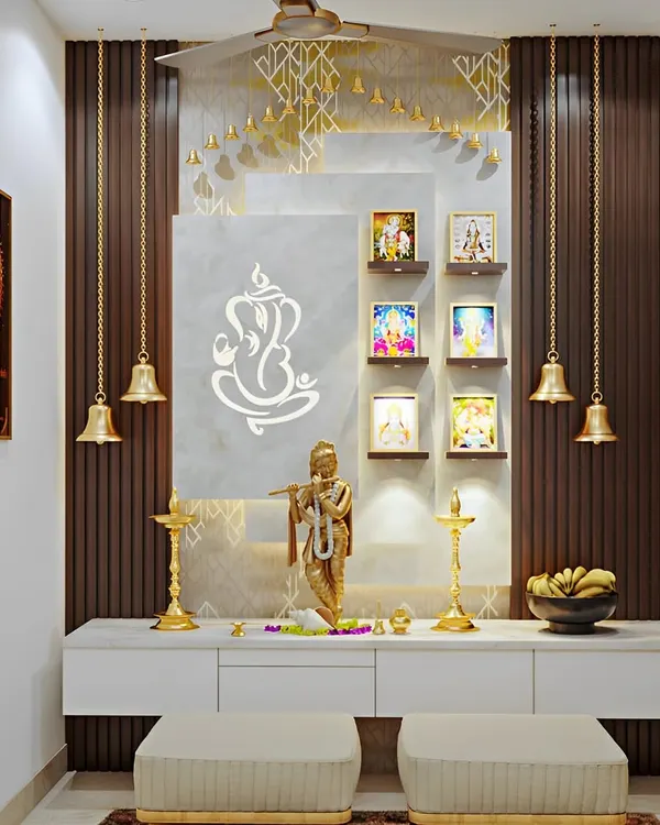 This pooja unit is a beautiful blend of modern and traditional elements. It features a Ganesha graphic on a marble-like panel, hanging brass bells, and built-in seating, creating a complete and serene prayer corner.