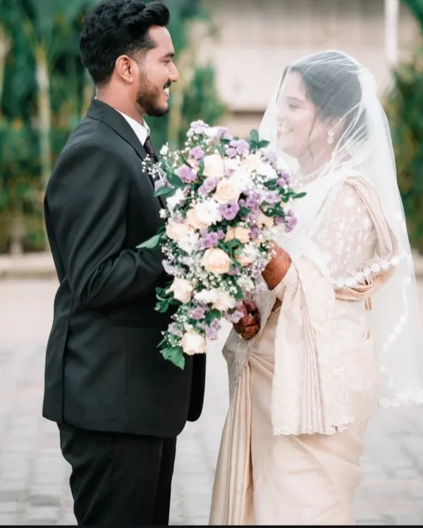 A romantic portrait of a Christian bride and groom sharing a quiet moment after their ceremony, bouquet in hand.