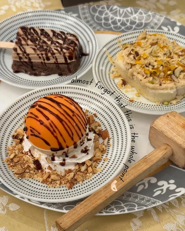 In the middle of all the wedding madness, don't forget the main point. This stunning plate of desserts, featuring a chocolate dome, kulfi, and more, is a reminder that food is the celebration.