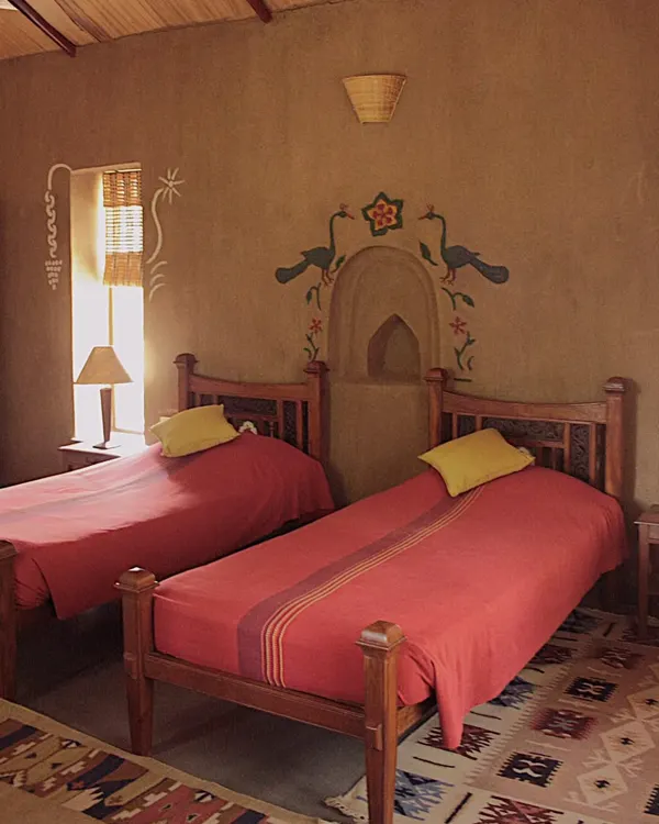 This vernacular homestay in rural Madhya Pradesh is the result of a deep collaboration with the local community. The space is built with earth, shaped by local hands, and decorated with murals that tell the stories of the families who live here, offering a truly authentic and sustainable travel experience.