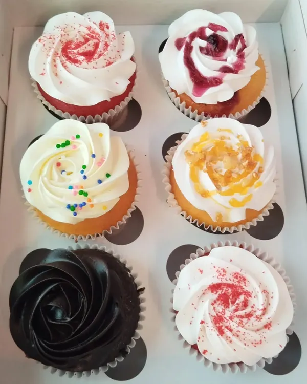 A box of our happiness, featuring an assortment of our most popular cupcake flavors like red velvet, chocolate, and vanilla blueberry. Perfect for any office occasion.